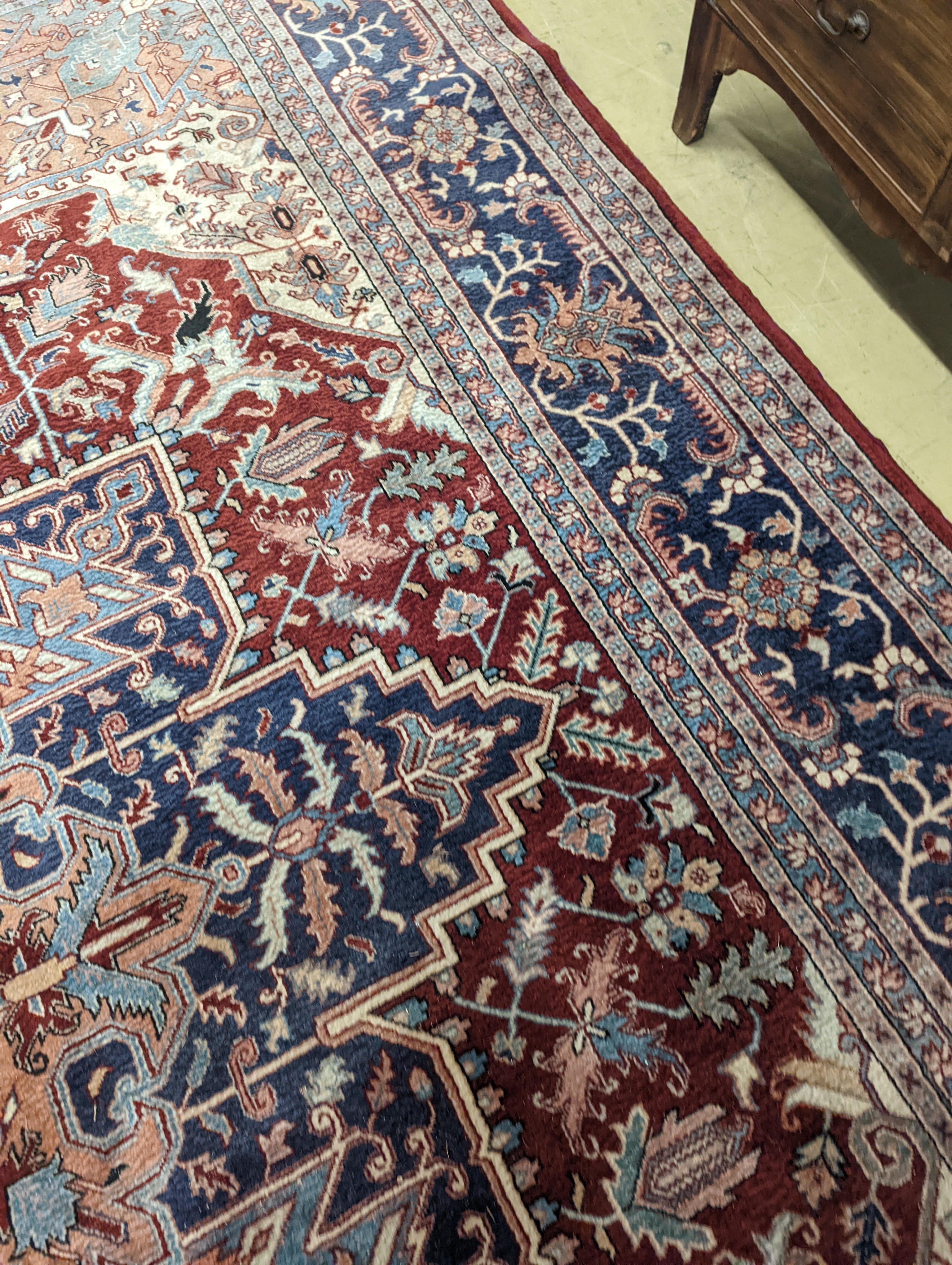 A large Caucasian style red ground carpet, 460 x 330cm